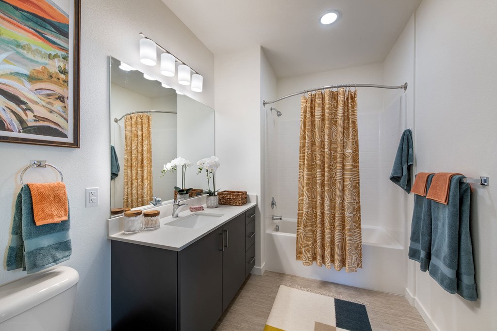 a bathroom with a shower and a sink and a mirror