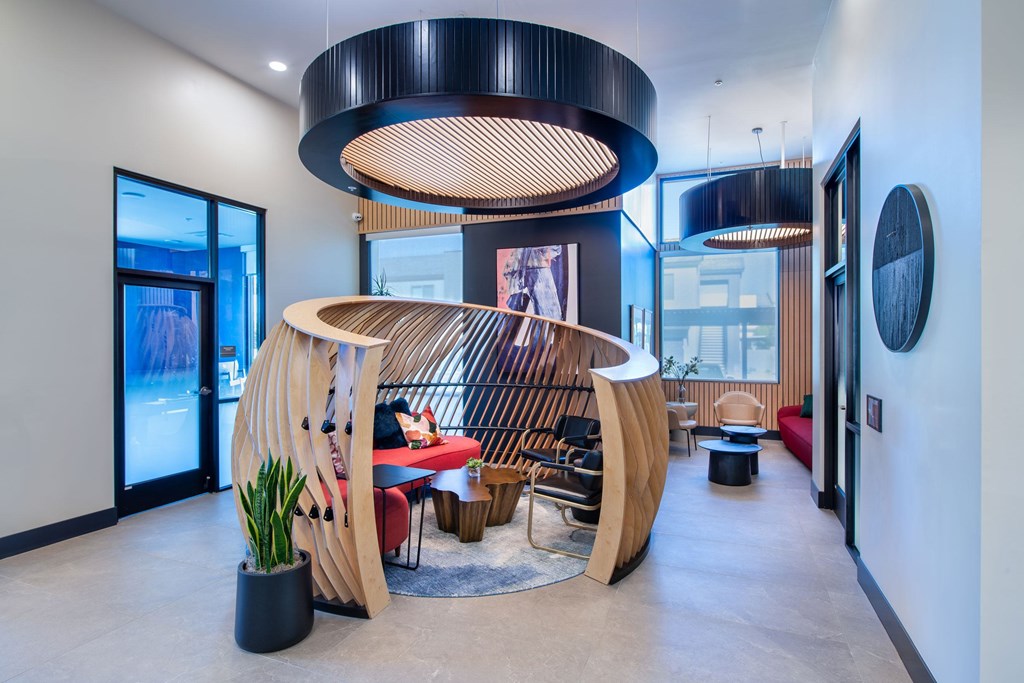 a living room with a wooden spiral staircase and a table and chairs