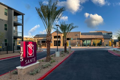 an apartment building with a sign that says 5 smile in front of it