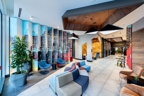 A modern living room with a large sectional sofa and a wooden ceiling.