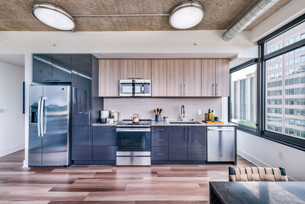A modern kitchen with wooden cabinets and stainless steel appliances.