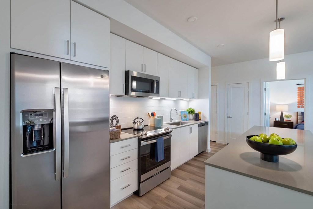 a kitchen with stainless steel appliances and white cabinets