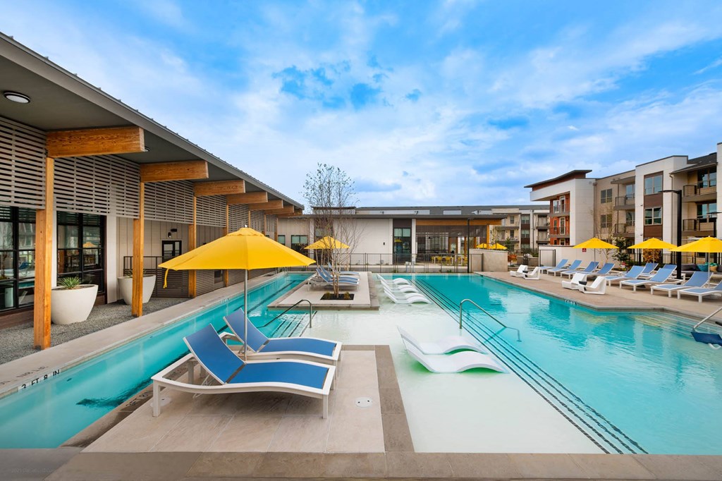 Corsair Apartments Pool with Lounge Chairs