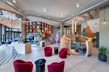 A modern interior with a wooden chair and a red sofa.