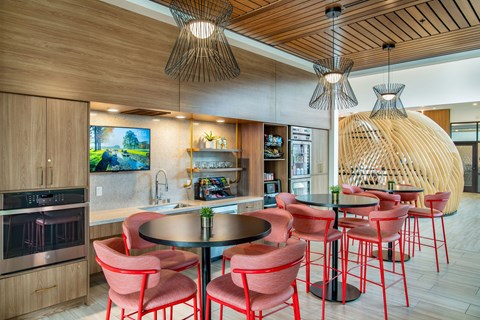 a dining area with chairs and tables and a kitchen