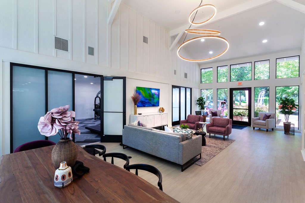 a living room filled with furniture and a large window