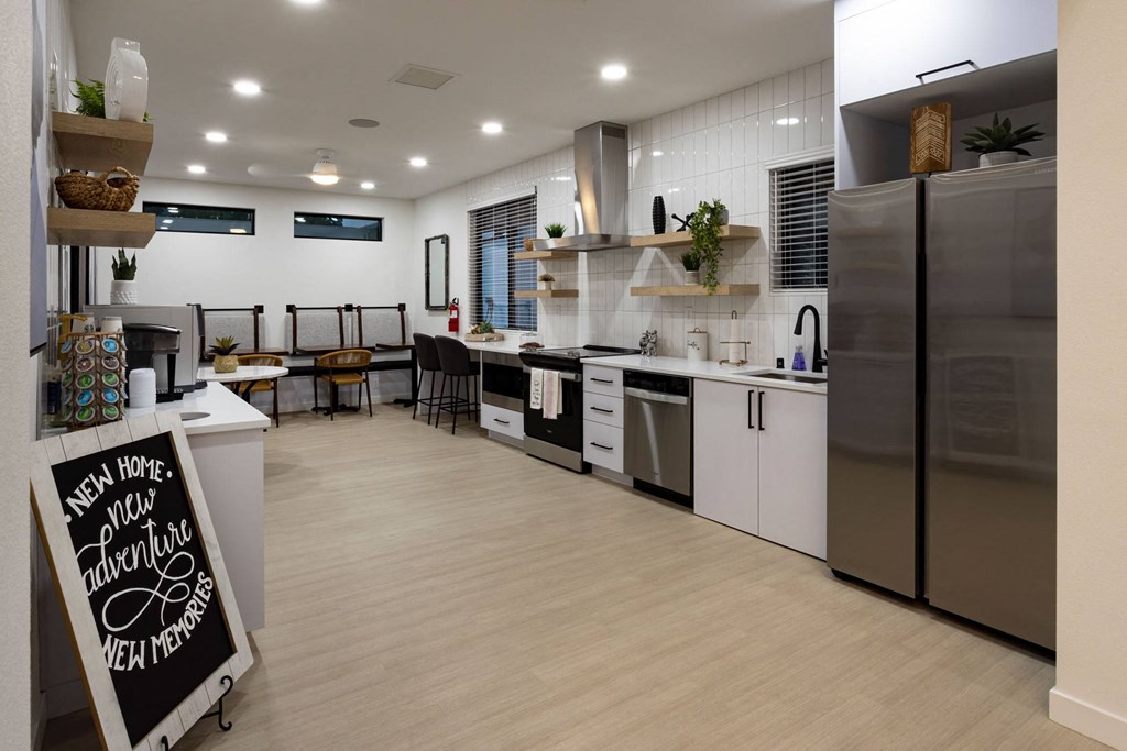 a kitchen with white cabinets and stainless steel appliances