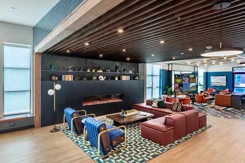 A modern living room with a wooden ceiling and a black wall.
