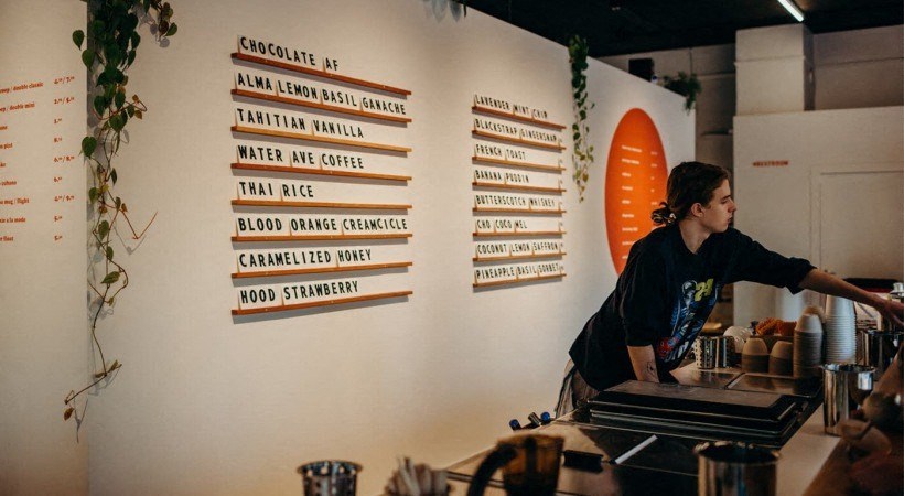 a woman is working at a counter at a restaurant