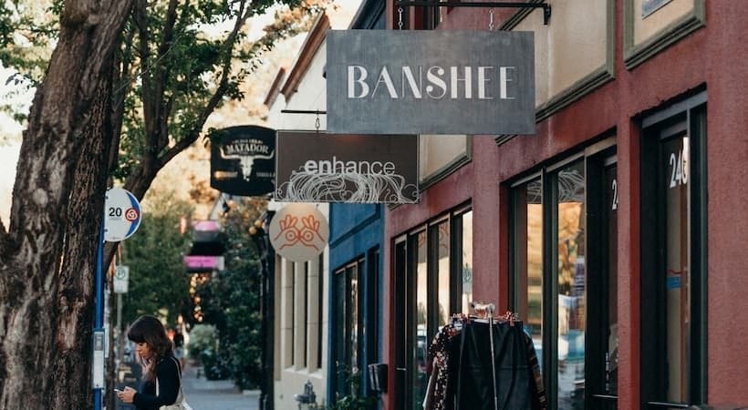 a woman talking on her cell phone in front of a building