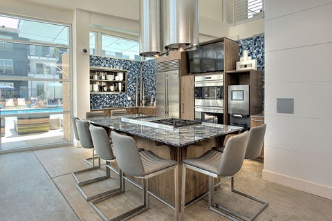a kitchen with a marble counter top and a table with chairs