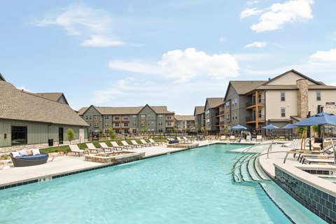swimming pool lined with lounge chairs