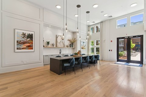 A modern kitchen with a dining table and chairs.