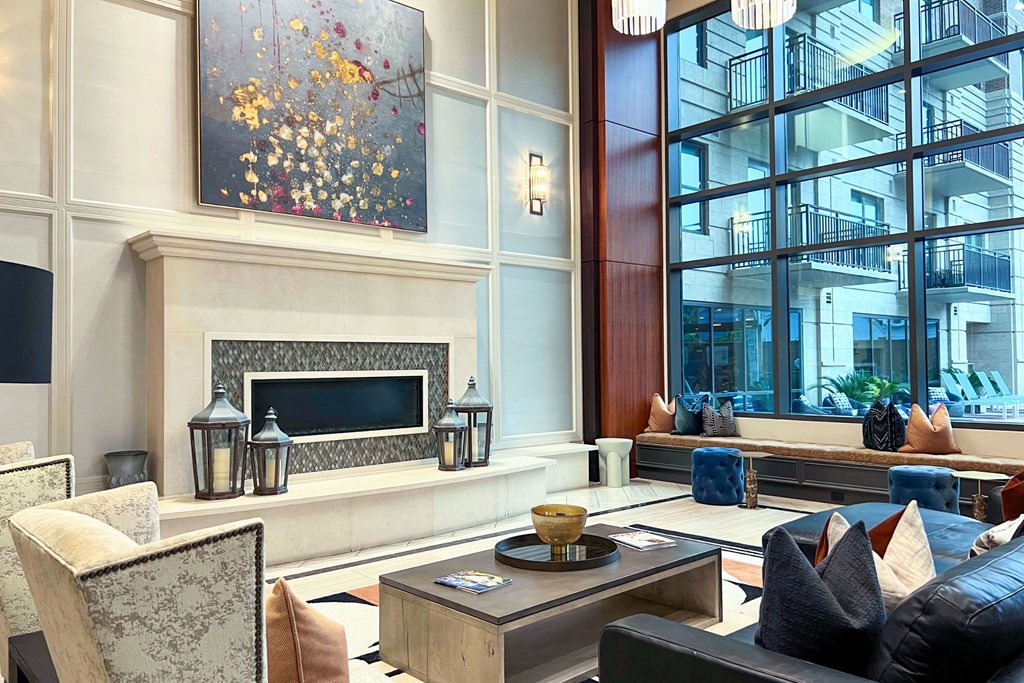 a living room with a fireplace and large windows