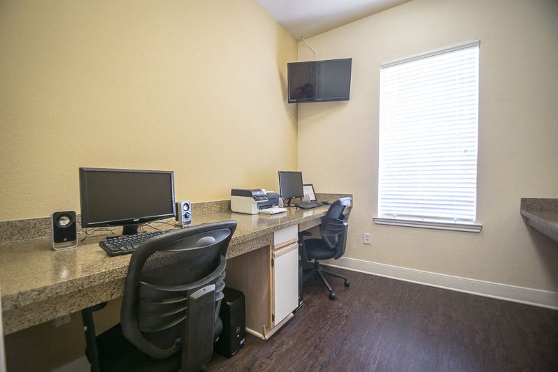 an office with a desk with a computer and a monitor at Fountains of Denton in Denton, TX