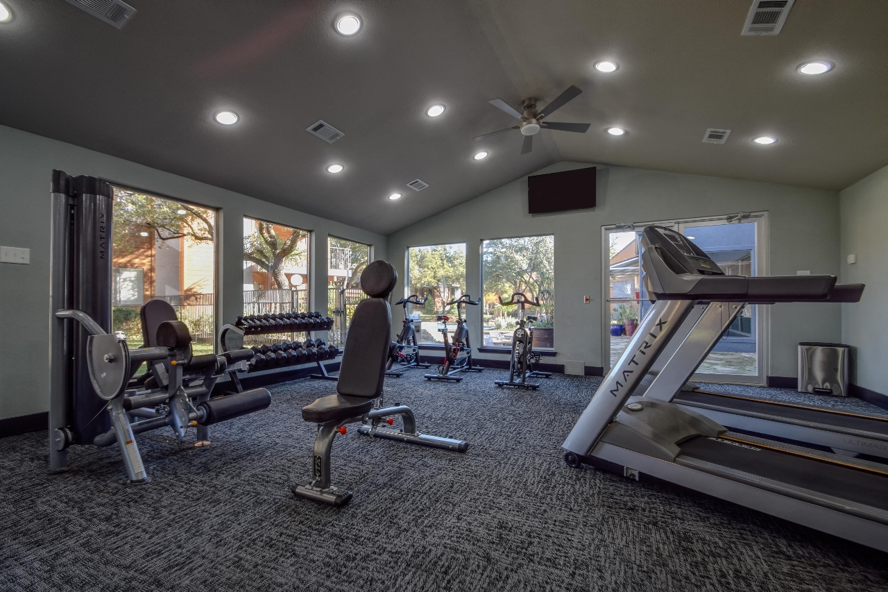 spacious gym with cardio equipment and windows at the preserve at greatstone