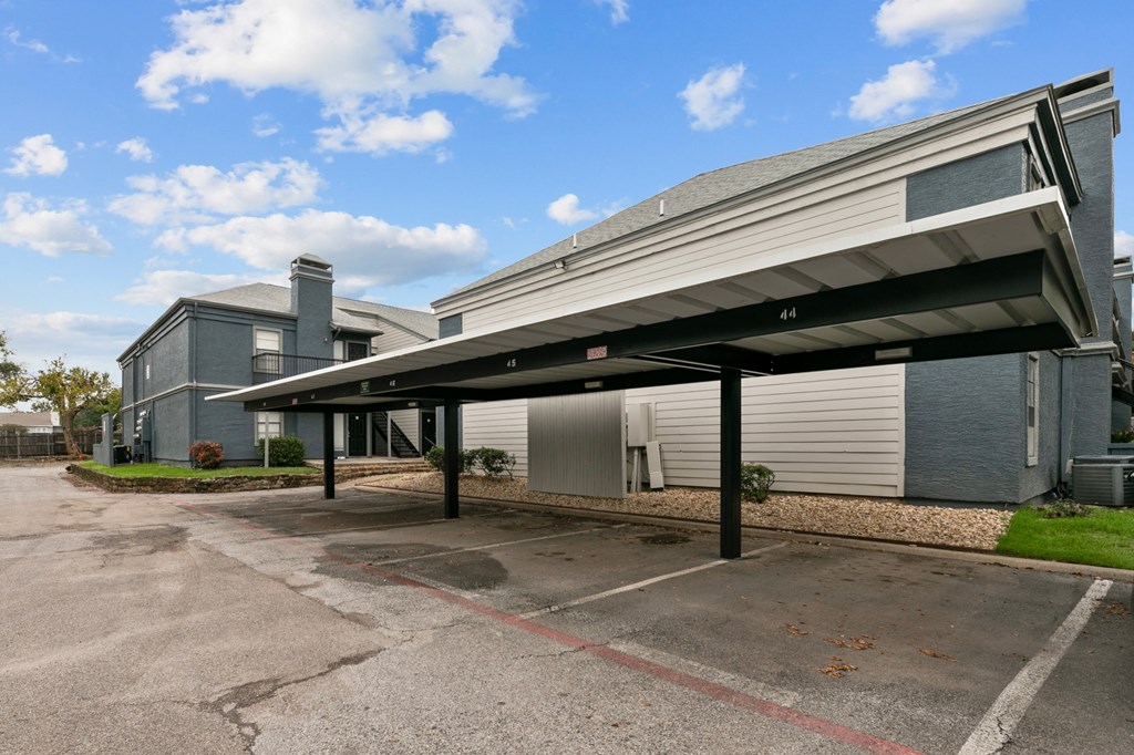 a parking lot in front of a building with a garage