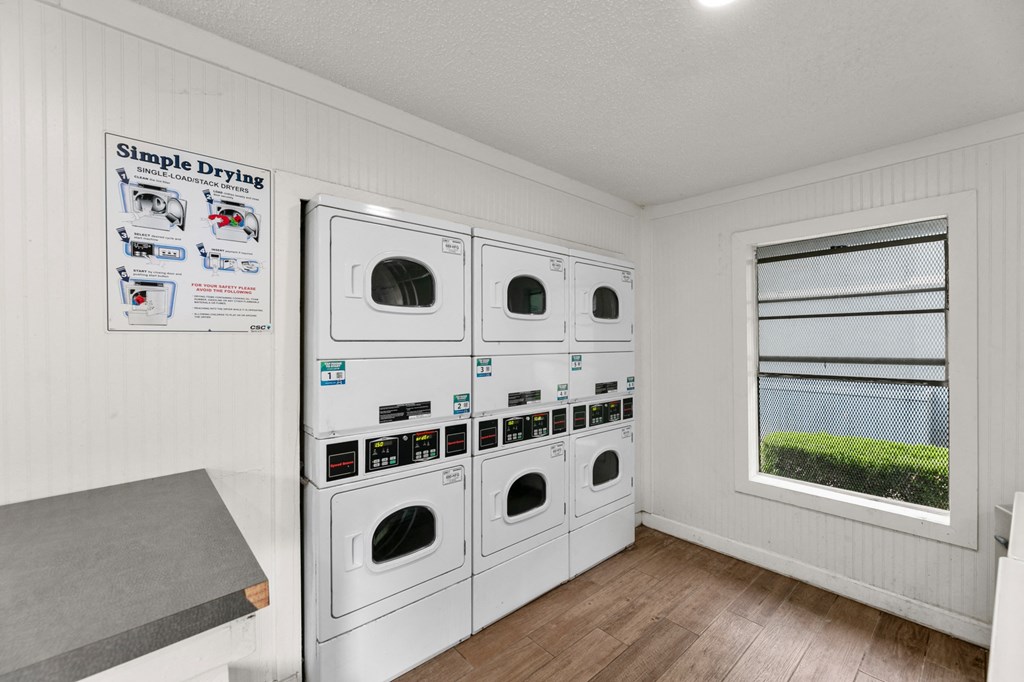 a washer and dryer in a laundry room with a window