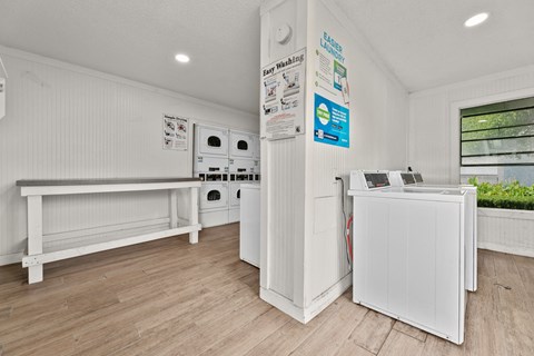 a laundry room with white appliances and a counter at 5636 Apartment Homes, Dallas, 75254