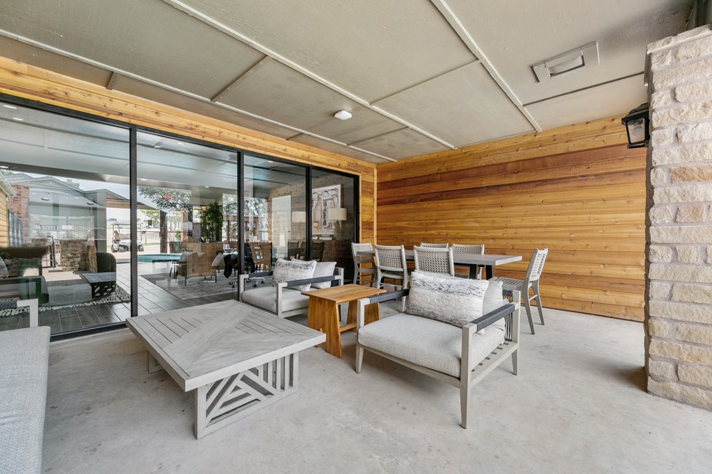 a covered patio with chairs and tables at The Hills at Ironhorse, North Richland Hills, TX