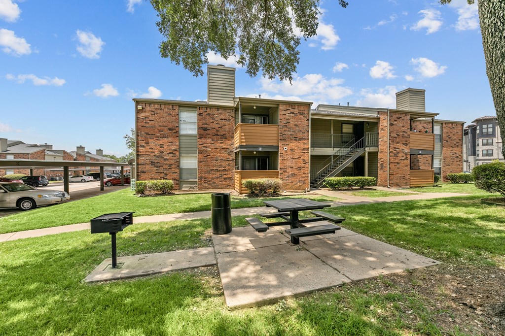 a picnic area with a grill in front of a building at The Hills at Ironhorse, North Richland Hills, 76180