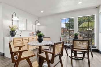 A dining room with a round table and chairs.