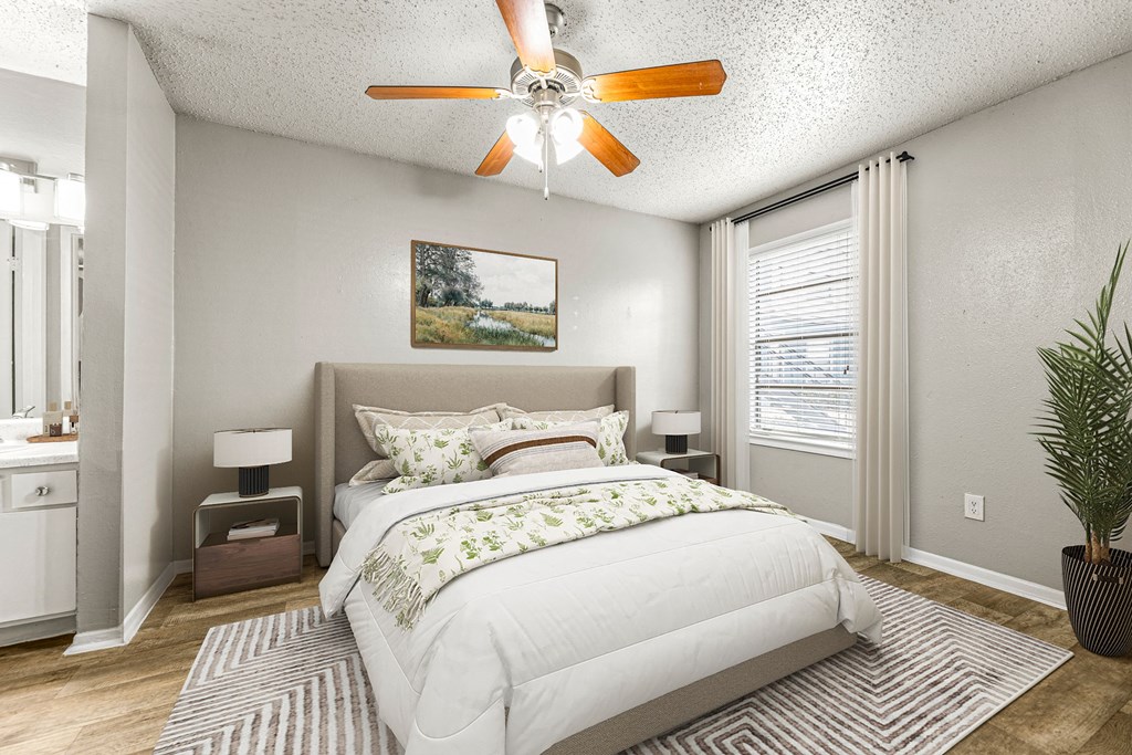 a bedroom with a bed and a ceiling fan