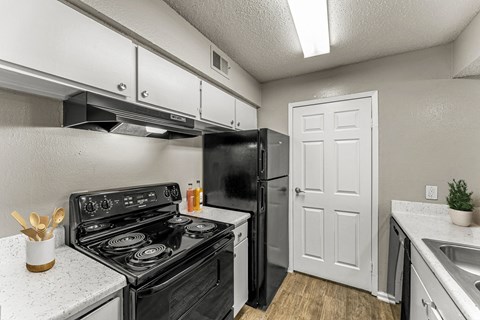 a kitchen with a stove refrigerator and sink at 5636 Apartment Homes, Dallas, 75254