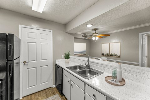 a kitchen with a sink and a ceiling fan at 5636 Apartment Homes, Dallas, 75254