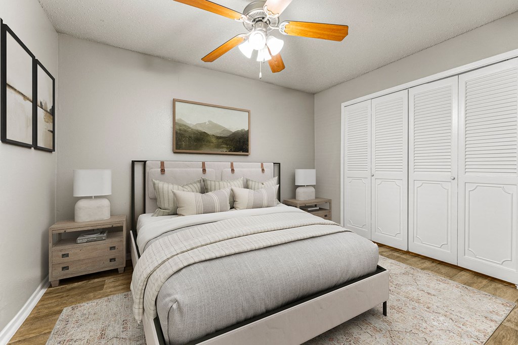 a bedroom with a bed and a ceiling fan