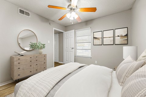 a bedroom with a bed and a ceiling fan at 5636 Apartment Homes, Dallas, 75254