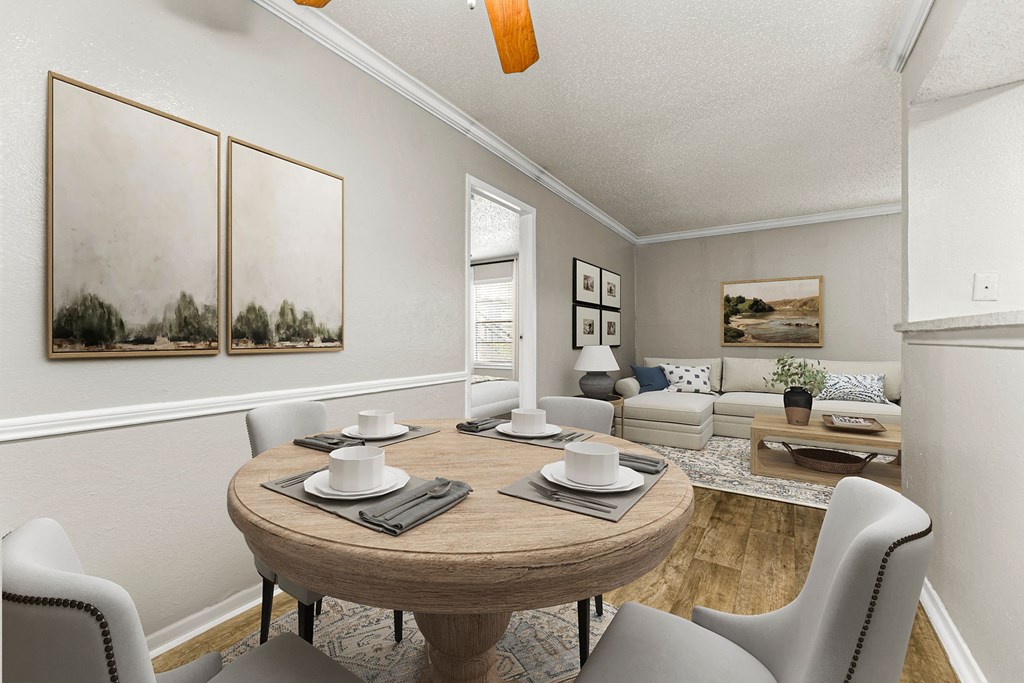 a dining room with a table and chairs