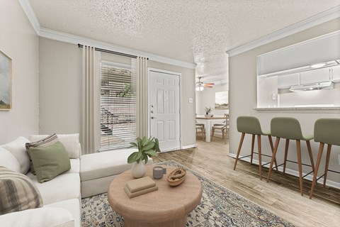 a living room with a couch and a table at 5636 Apartment Homes, Dallas