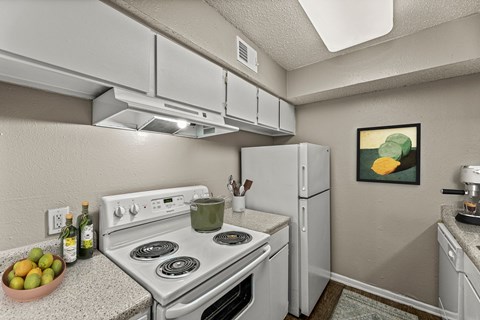 our apartments have a kitchen with white appliances and granite counter tops at 5636 Apartment Homes, Dallas, TX