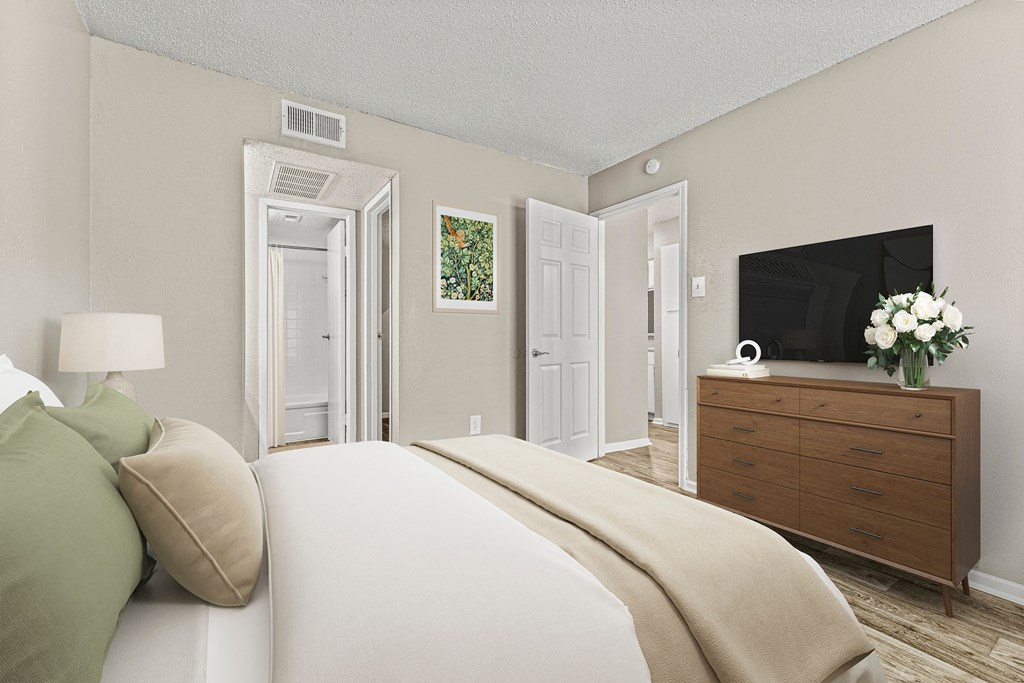 a bedroom with a bed and a tv