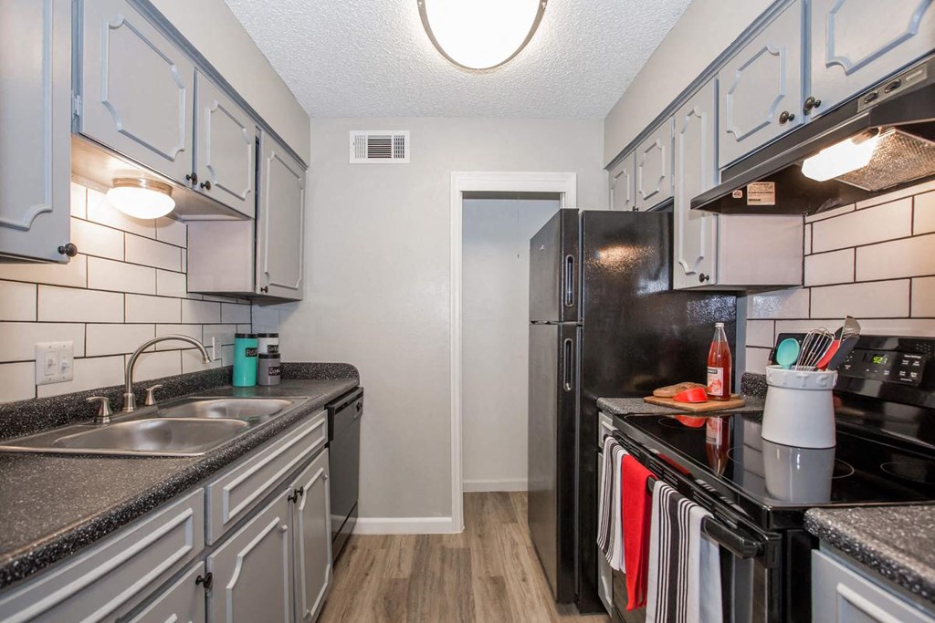 a kitchen with a sink and a refrigerator