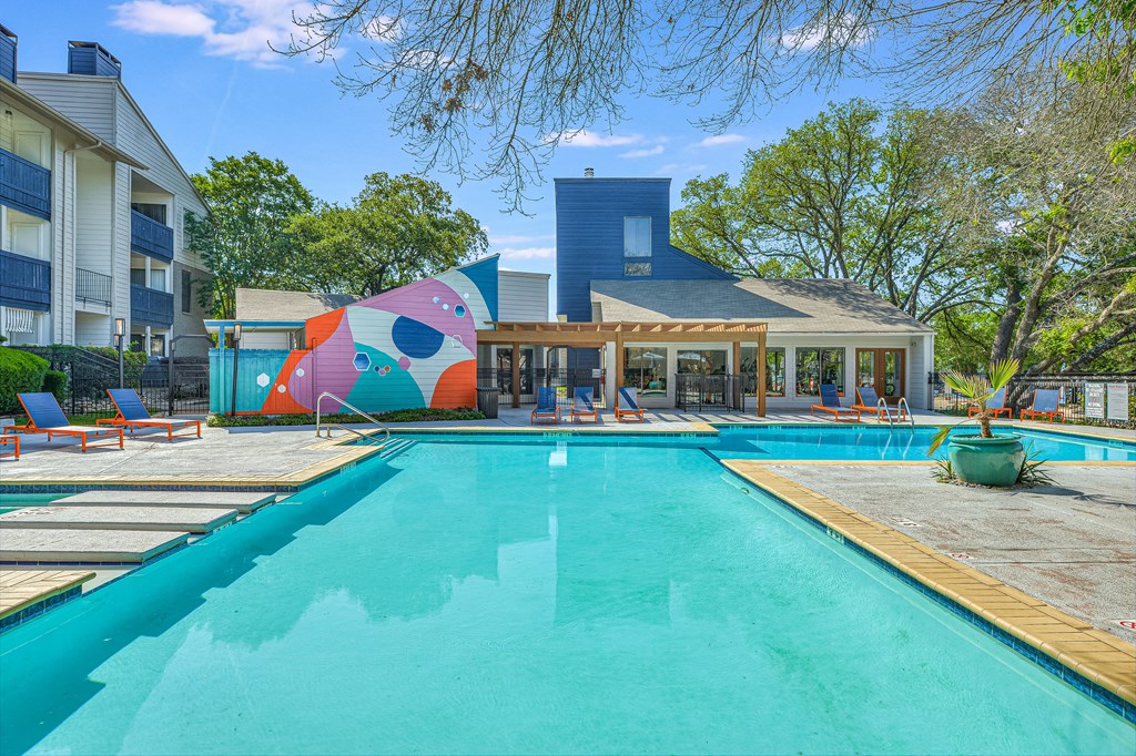 a swimming pool with a building in the background at Peaks at Northwest Hills Apartments, Texas, 78731