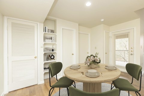 A dining room with a round table set for four.