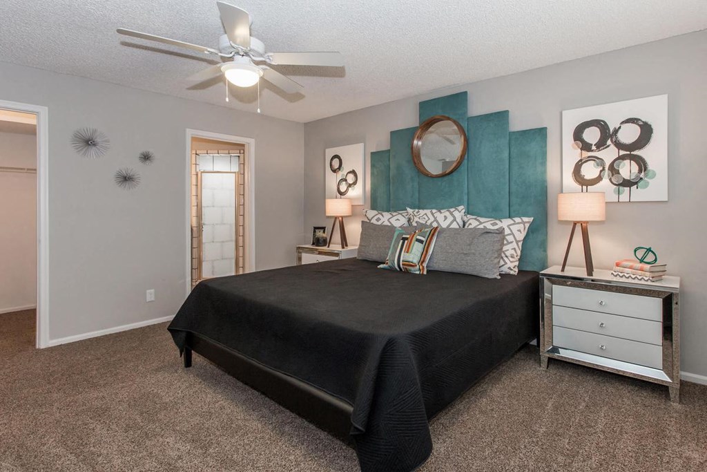 a bedroom with a bed and a ceiling fan