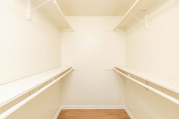 Empty room with white walls and wooden floor.