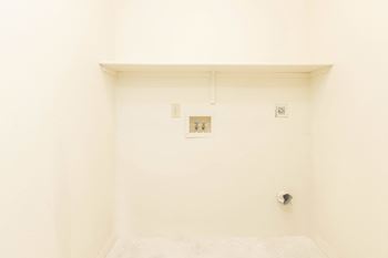 A white wall with a small picture and two switches.
