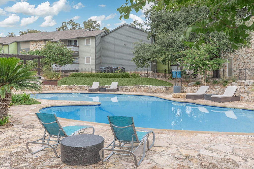 the swimming pool at the whispering winds apartments in pearland