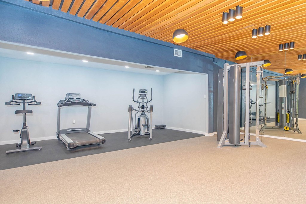 a room filled with stainless steel pipes and urinals