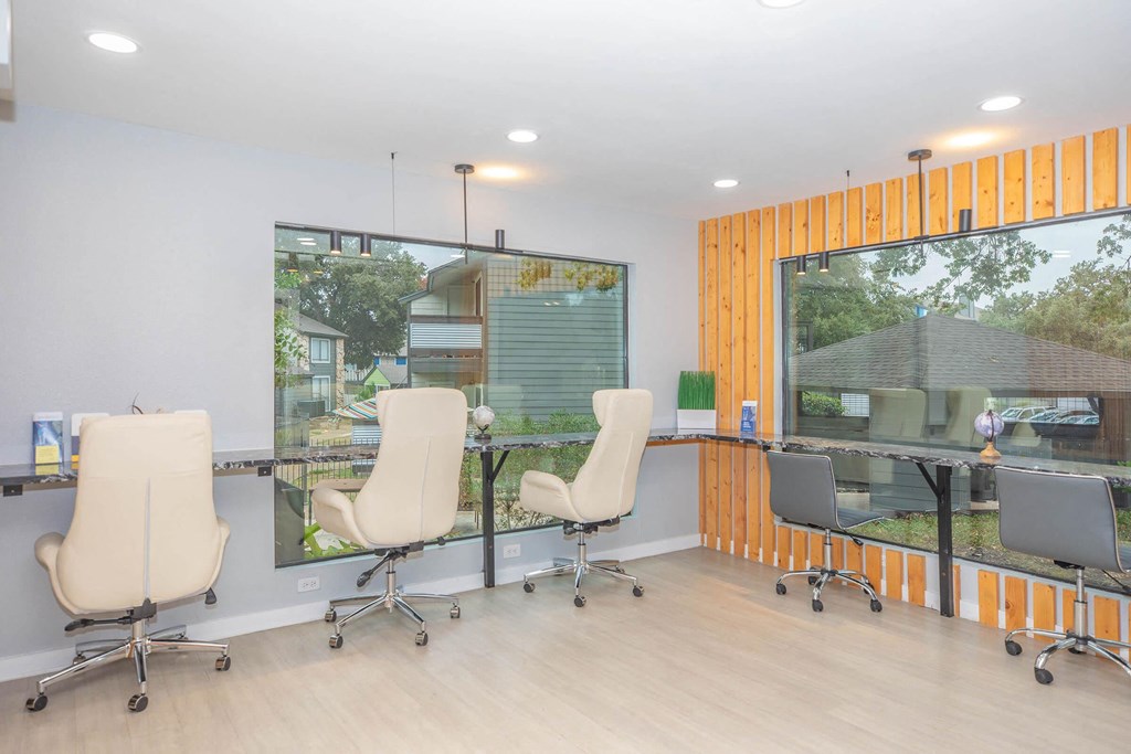 a room with chairs and a table and a window