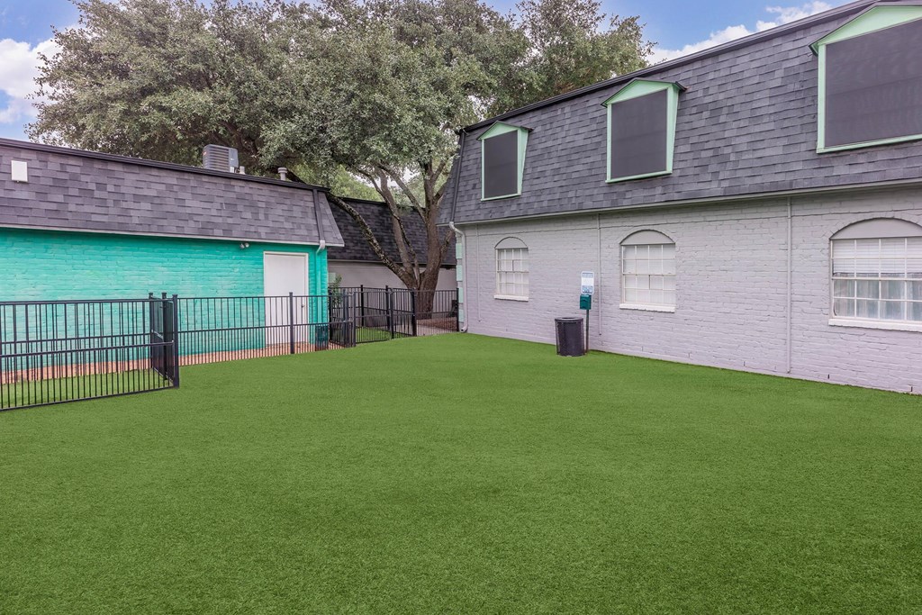 a yard with a fence in front of a house