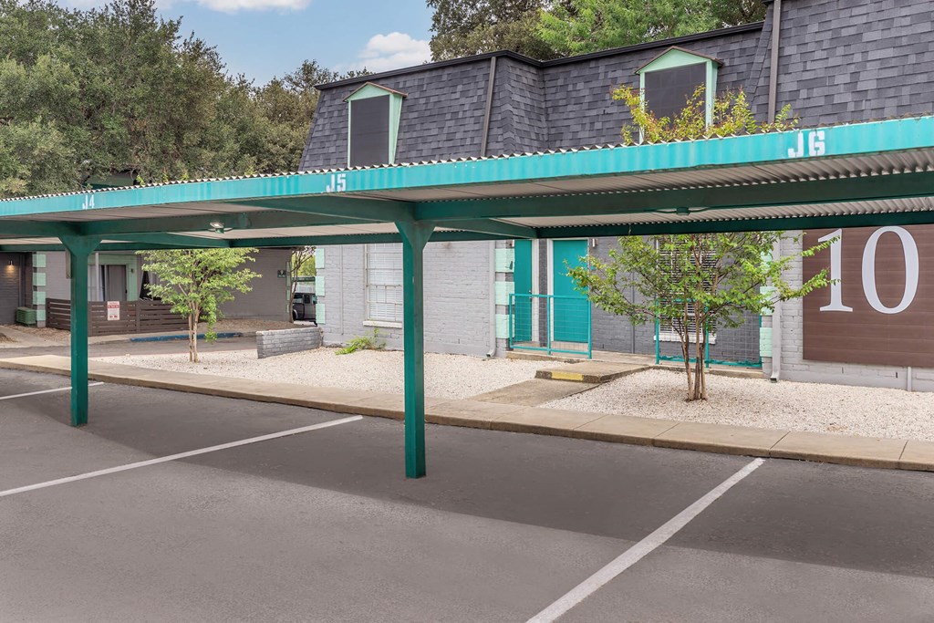 an empty parking lot in front of a building with numbers on it