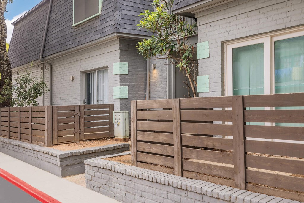 a wooden fence in front of a house