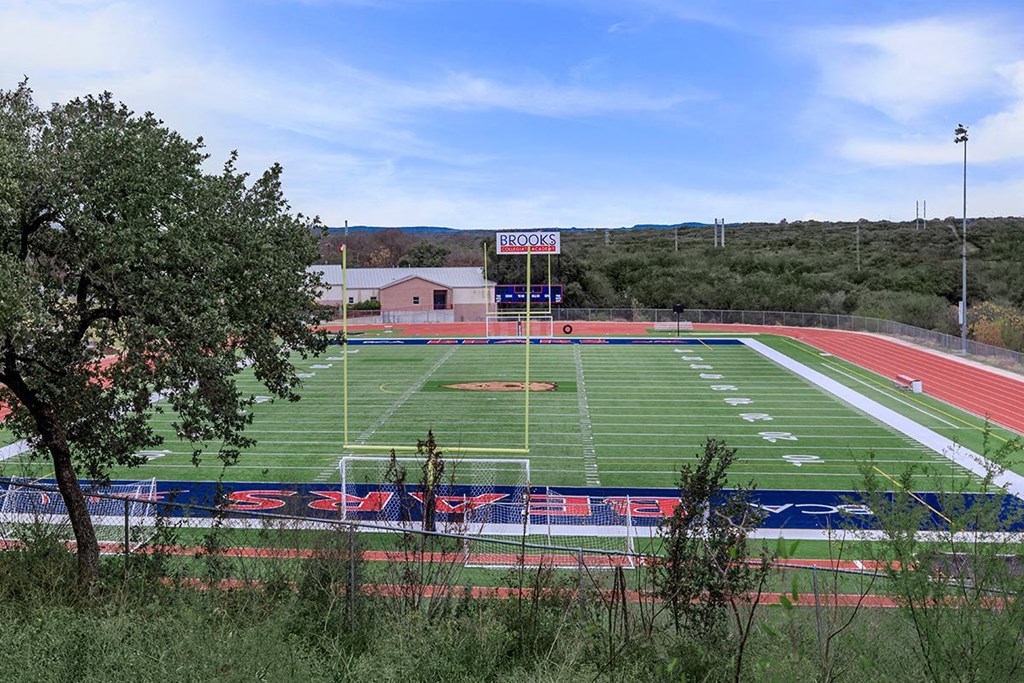 a soccer field is shown with a stadium in the background