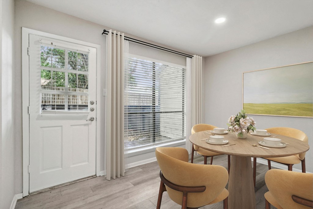 a dining room with a table and chairs