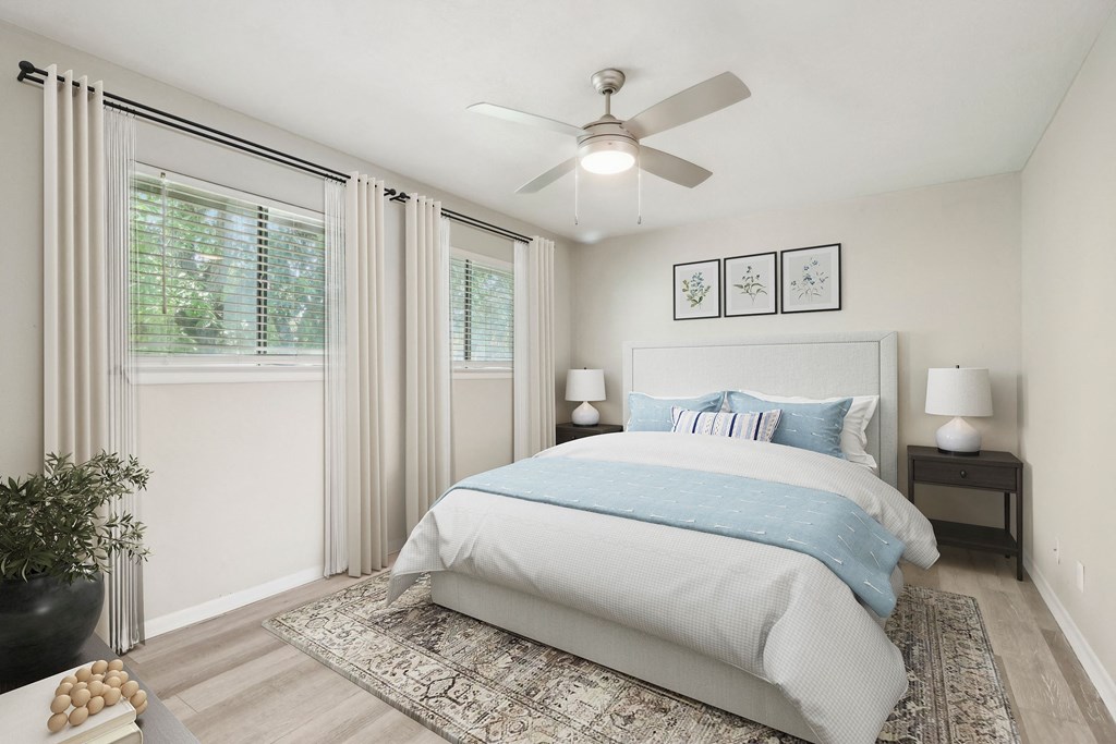 a bedroom with a bed and a ceiling fan